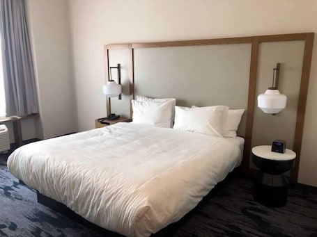 Desk, laptop workspace, iron/ironing board, bed sheets