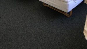 A room with two single beds, a small bedside table, and a wall-mounted light fixture. - Motel Hadsten (Hadsten)