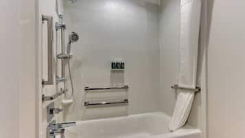 A modern bathroom with a freestanding bathtub, chrome fixtures, and a showerhead.