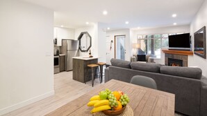 A modern apartment with a kitchen, dining area, and living room.