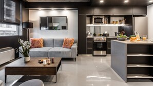 A modern kitchen with a built-in oven, microwave, and refrigerator.