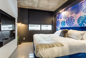 Relax in a spacious bedroom with a large bed and flat-screen TV.