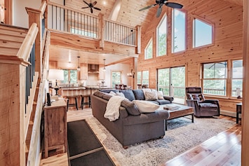 The great room has an open floor plan & expansive windows facing mountain views.