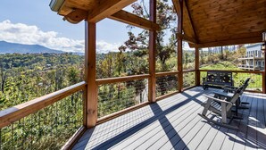 Eine Holzterrasse mit Blick auf eine gebirgige Landschaft.