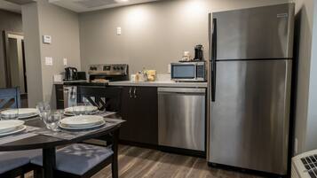 A modern kitchen with stainless steel appliances, a dishwasher, and a microwave.