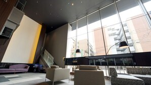 A modern lobby with a staircase, seating area, and large windows. - Best Western Plus Fukuoka Tenjin-minami (Fukuoka)