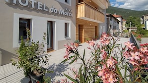 A hotel named 'HOTEL da Marco' with a modern facade, balconies, and potted plants in the foreground. - Hotel da Marco (Vigo di Cadore)