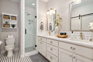 Bathtub, hair dryer, towels, shampoo