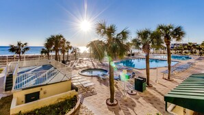 A pool area with multiple pools, palm trees, and a view of the ocean. - The Summit by Forehand Rentals (Panama City Beach)