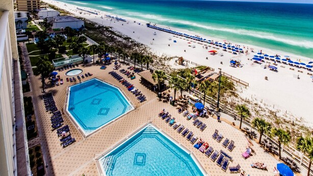 A resort with two large swimming pools, a beach, and a view of the ocean. - The Summit by Forehand Rentals (Panama City Beach)