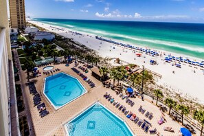 A resort with two large swimming pools, a beach, and a view of the ocean. - The Summit by Forehand Rentals (Panama City Beach)