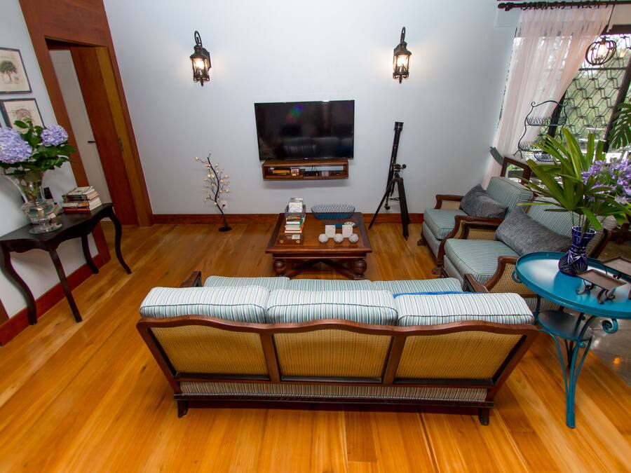 A living room with a sofa, a coffee table, a TV, and a lamp.