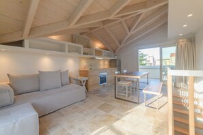 A modern kitchen with a built-in oven and a dining area with a table and chairs.