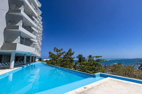 Outdoor pool, open 8:00 AM to 6:00 PM, pool umbrellas, sun loungers