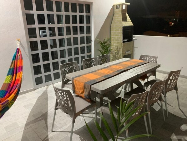 Enjoy al fresco dining in this outdoor space, complete with a table for four and comfortable seating.