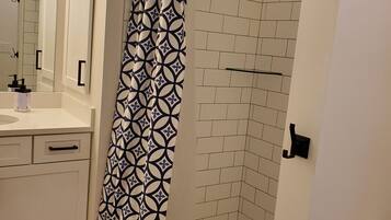 Shower, hair dryer, towels, shampoo
