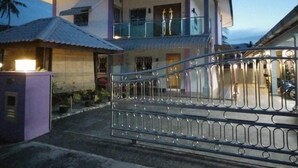 A two-story house with a balcony and a gated entrance. - Ocean Lodge (Langkawi)