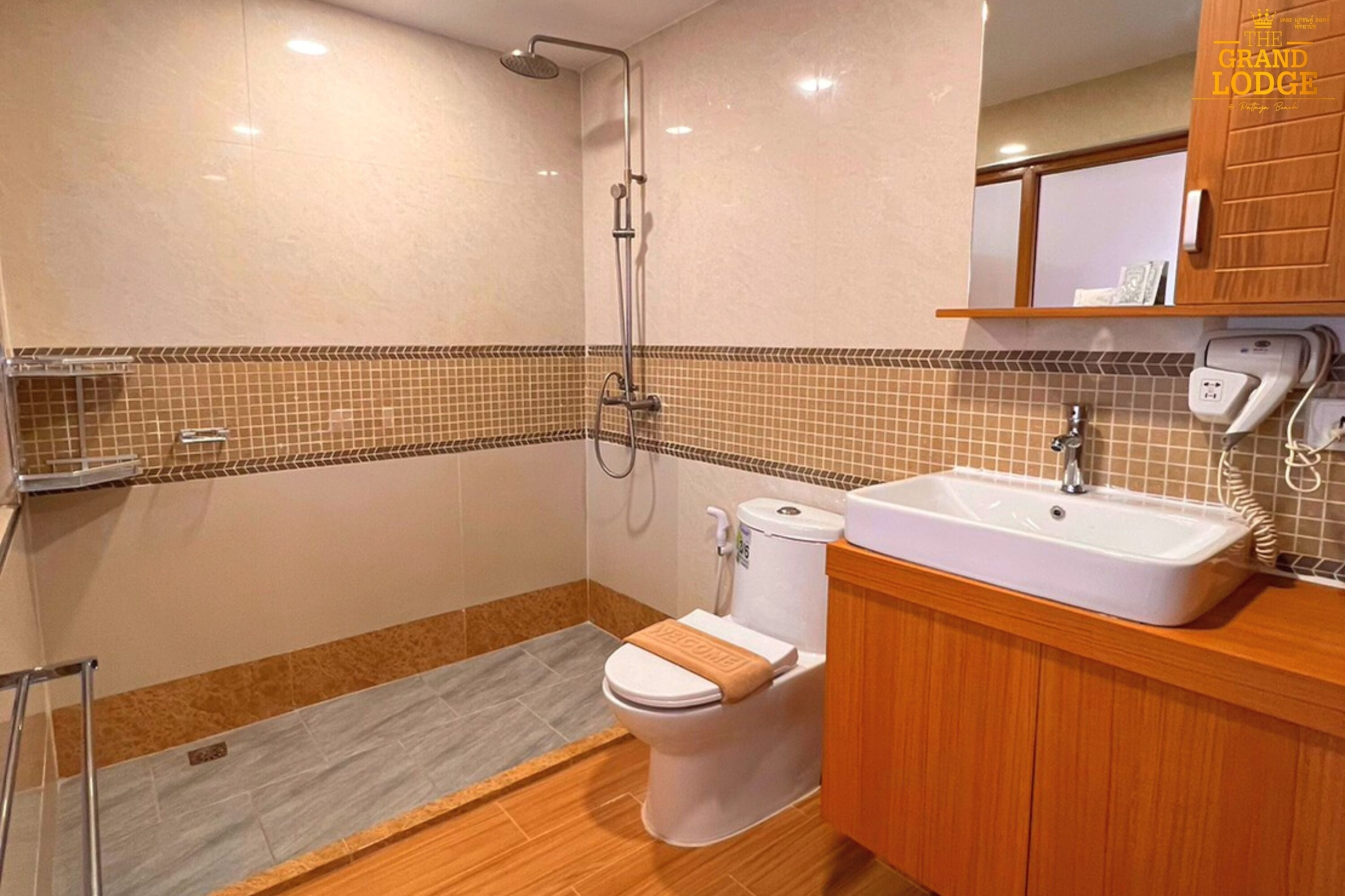 A bathroom with a shower, toilet, and sink.