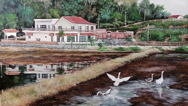 A two-story building with a red roof and multiple windows, surrounded by lush greenery and a body of water with birds. - Guesthouse Beluru (Kuala Kangsar)