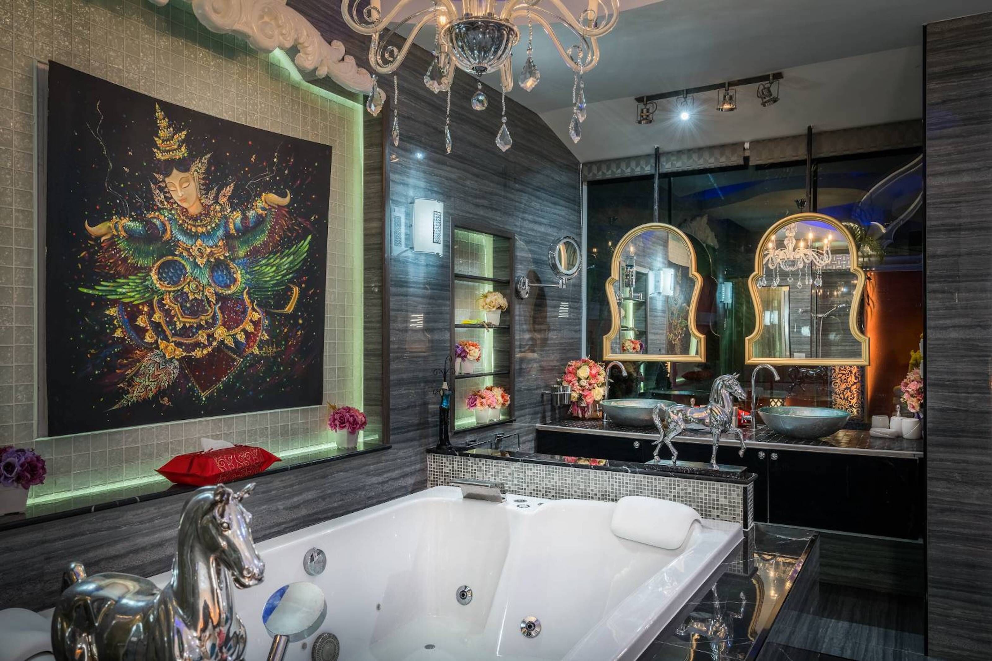 A modern bathroom with a large bathtub, two mirrors, and a decorative painting.