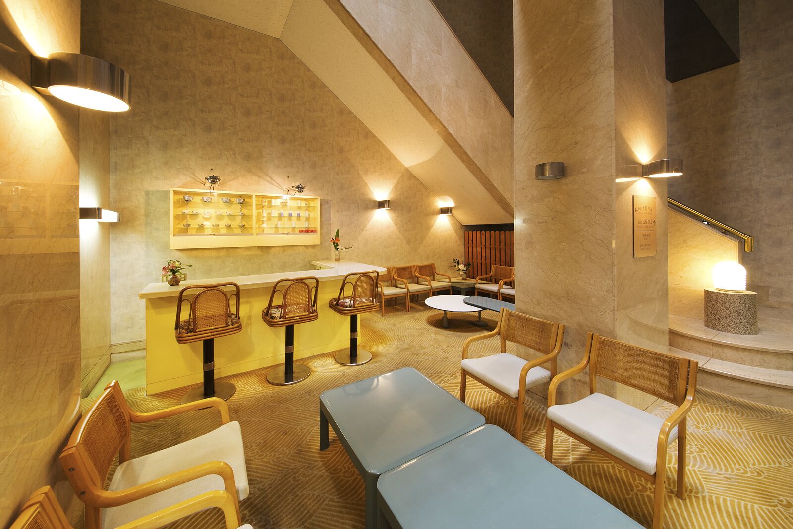 A modern interior with a bar area, seating, and a patterned floor.