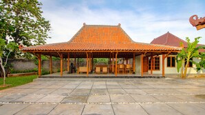 A traditional house with a tiled roof and wooden structure. - OYO 2634 Griya Birowo Syariah (Wonosari)