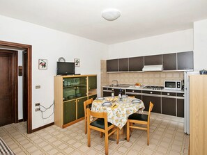 Microwave, toaster, freezer, dining tables