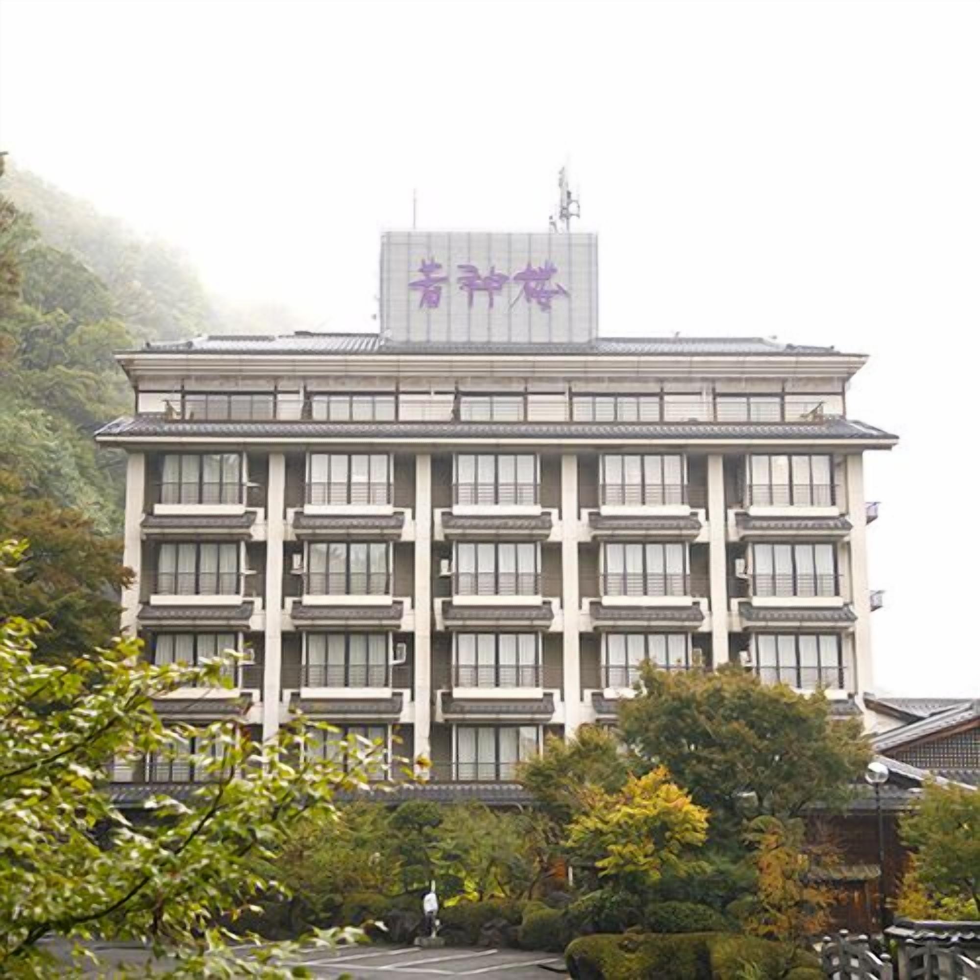 A multi-story building with a sign at the top.
