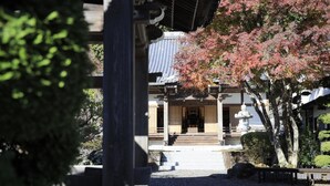 A traditional Japanese building with a tiled roof, a wooden entrance, and a stone pathway leading to the door. - Temple Hotel Habanobo (Minobu)