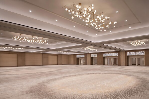 A spacious, well-lit conference room with multiple doors and a modern chandelier. - The Westin Anaheim Resort (Anaheim)
