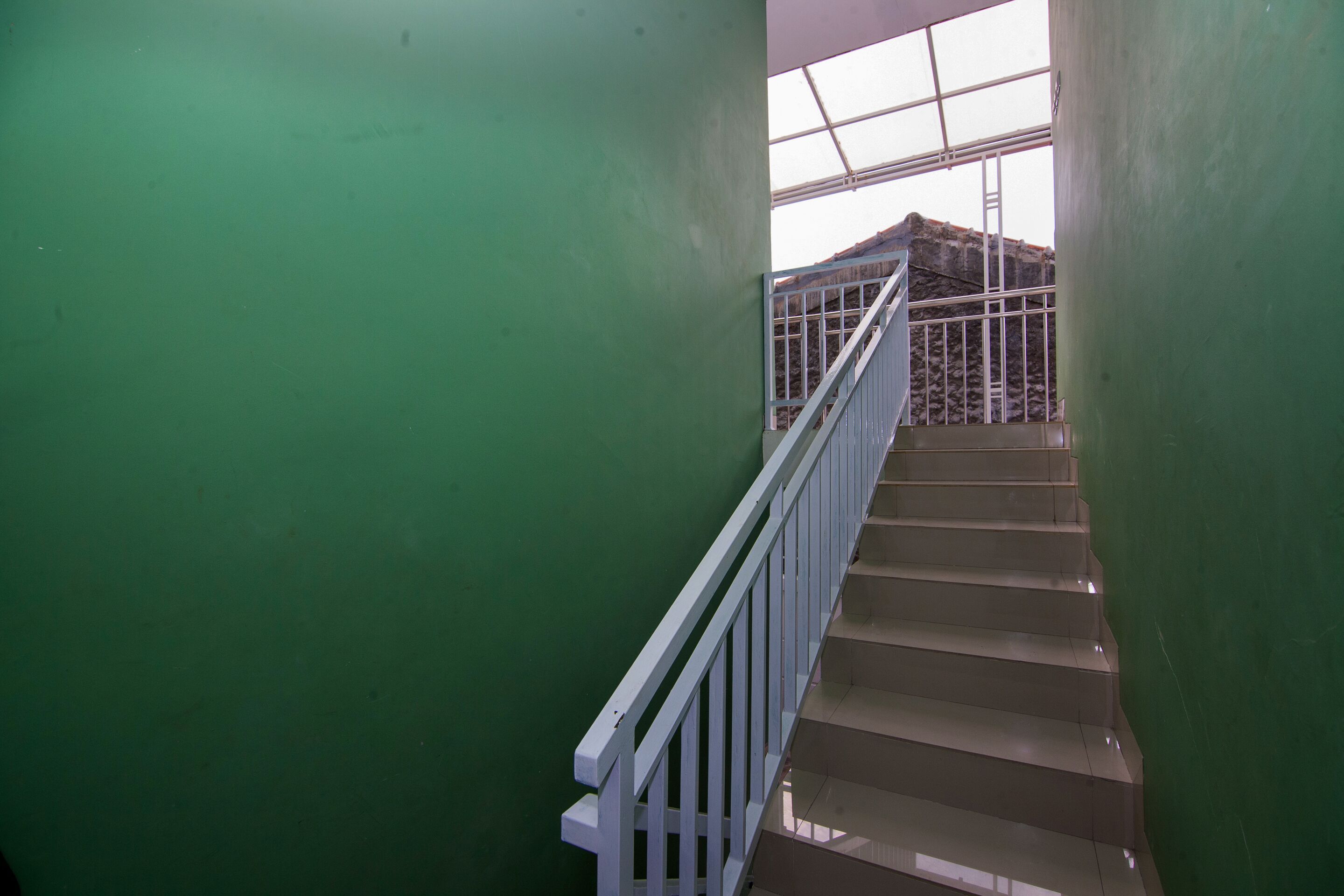 A staircase with white railings leading to an upper level.