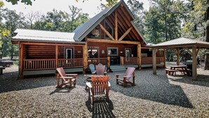 A rustic lodge with a prominent gable roof, wooden deck seating, and a covered picnic area. - R-N-R- Broken Bow/Hochatown- 2bd - Sleeps 8 (Broken Bow)