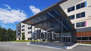 A modern building with a large glass entrance and the name 'aloft' prominently displayed. - Aloft by Marriott Little Rock West (Little Rock)