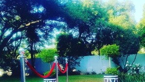 A red carpet leading to a building entrance with metal stanchions and red ropes. - Ouklip Place (Roodepoort)