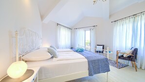 A bedroom with a bed, bedside table, lamp, chair, and curtains. - Summer House Magdalena (Malinska-Dubasnica)
