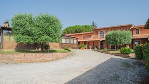 Un barrio residencial con un camino de grava que lleva a una casa de techo de tejas y paredes de ladrillo.