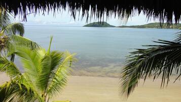 On the beach, white sand, sun loungers, beach umbrellas