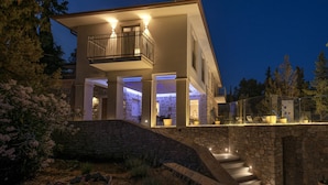 A modern two-story house with a balcony, stone walls, and a stone staircase leading to the entrance. - Luxury Villa Hvar Enigma with Pool (Jelsa)