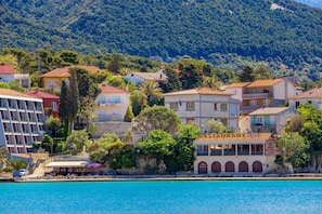 A coastal town with a variety of buildings, including a hotel with a pool and a restaurant. - Integrated Hotel Arbia - Margita Deluxe (Rab)