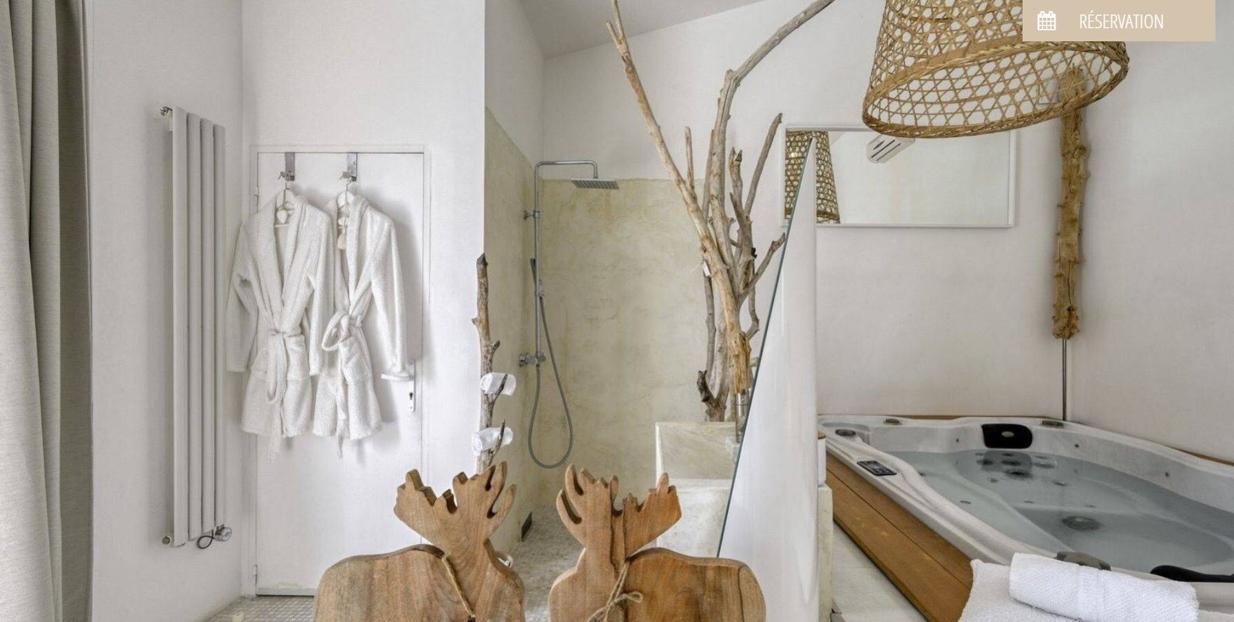 A modern bathroom with a bathtub, a shower, and a towel rack with robes.
