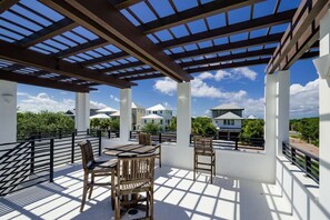 Relax in a shaded outdoor space with a pergola, perfect for dining or socializing.