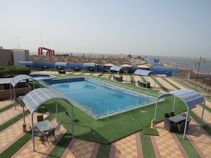 Outdoor pool, open 7:00 AM to 5:00 PM, free pool cabanas, pool umbrellas