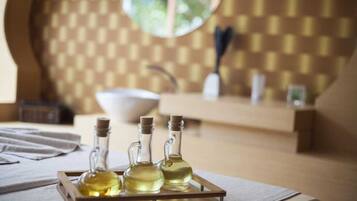 Relax in a serene spa room with a wooden tray, geometric patterned wall, and a large mirror.