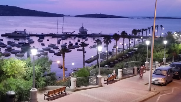 A waterfront promenade with benches, street lamps, and parked cars. - Porto Paolo side sea view ( Condominium ) (St. Paul's Bay)