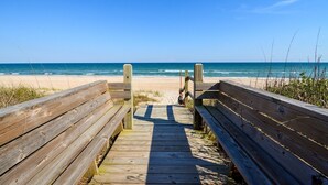 A wooden boardwalk leading to a beach with a clear view of the ocean. - Enjoy Sounds Beachy, an 8-bedroom haven in North Topsail Beach, NC with stunning water views. (North Topsail Beach)