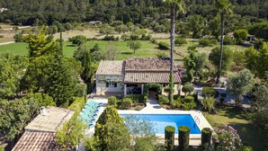 A villa with a swimming pool, surrounded by lush greenery and mountains in the background. - PLANA. Fantastic villa in a very quiet area (Pollensa)