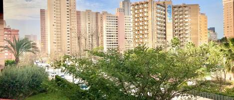 A residential area with high-rise buildings, a swimming pool, and greenery.