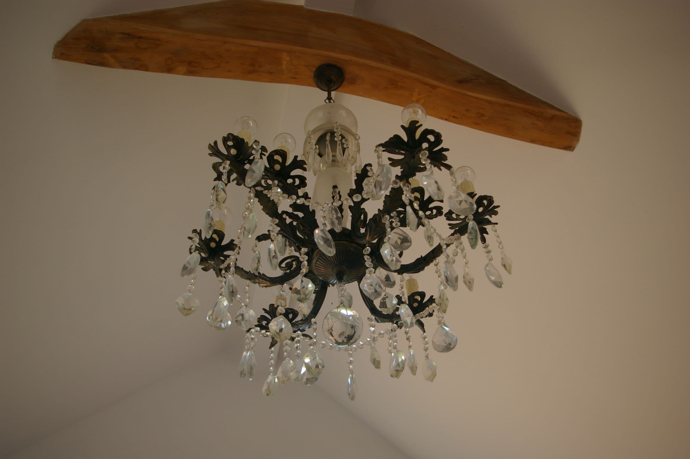 A chandelier with multiple arms and crystal decorations.