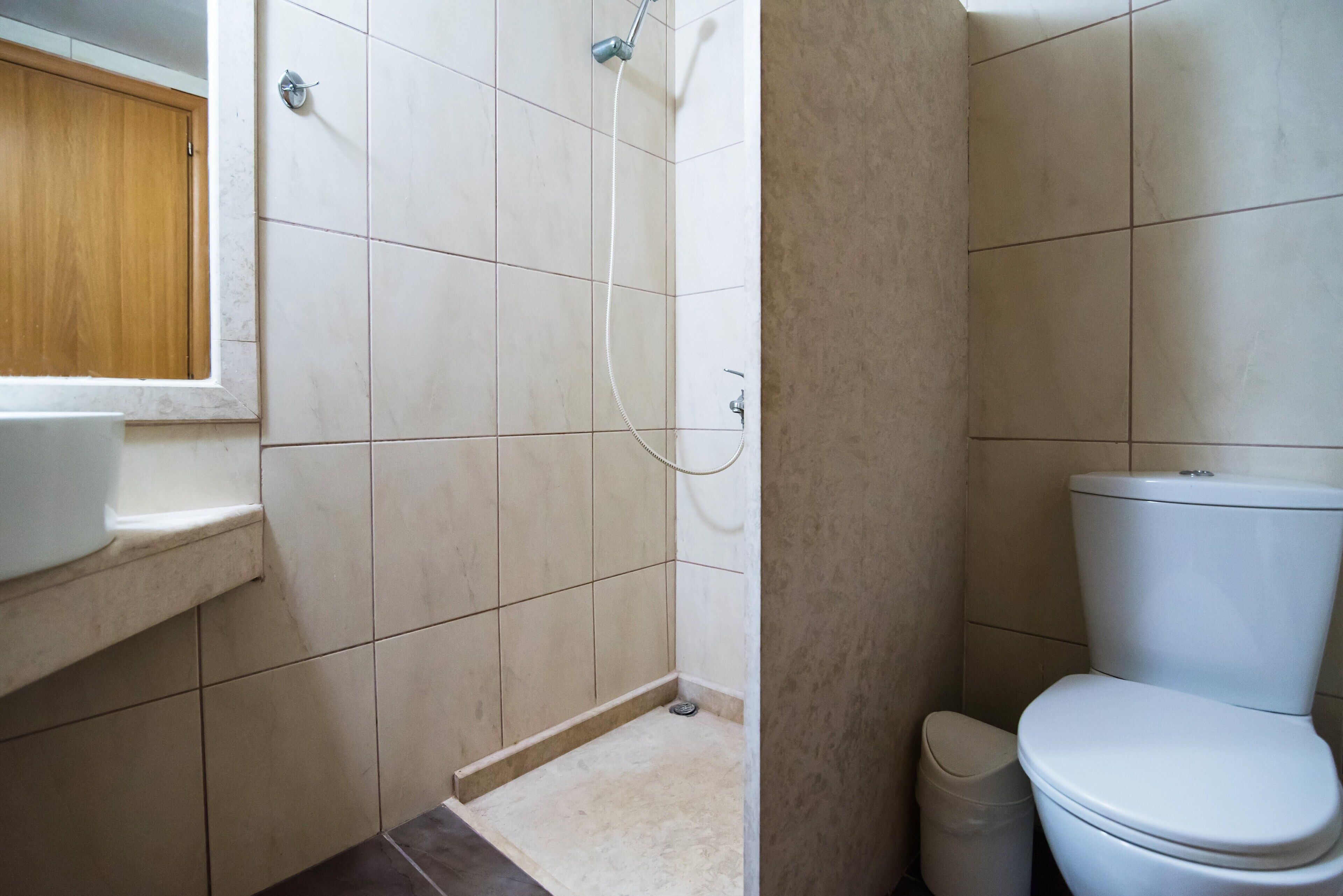 A bathroom with a shower, toilet, and sink.