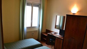A room with two single beds, a desk with a chair, a television, and a wardrobe. - Albergo Elena (Pianoro)